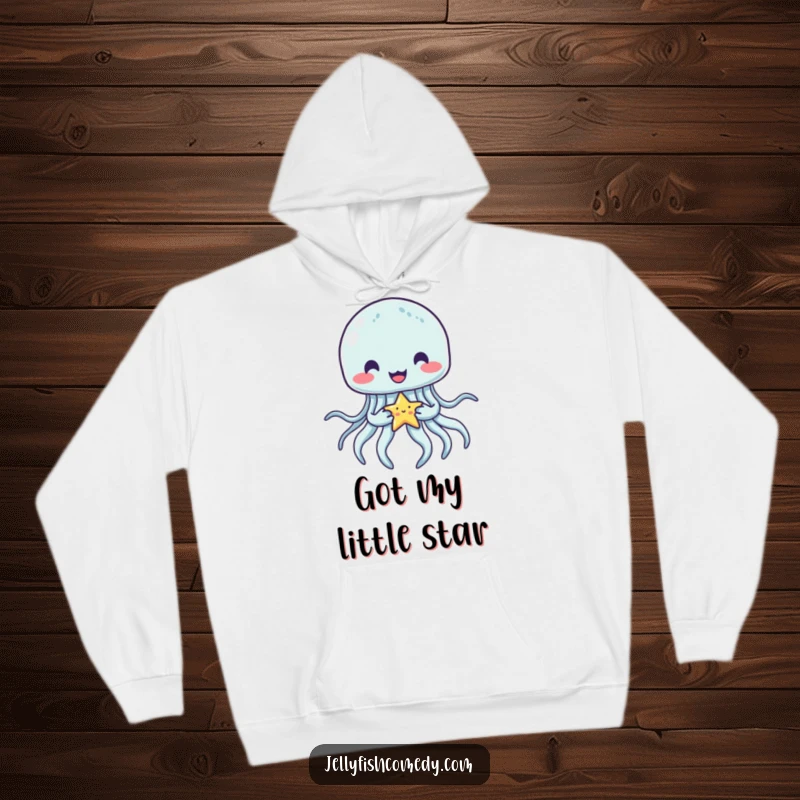 Funny jellyfish hoodie depicting a charming jellyfish happily holding a tiny star with its tentacles, radiating warmth and celestial wonder.