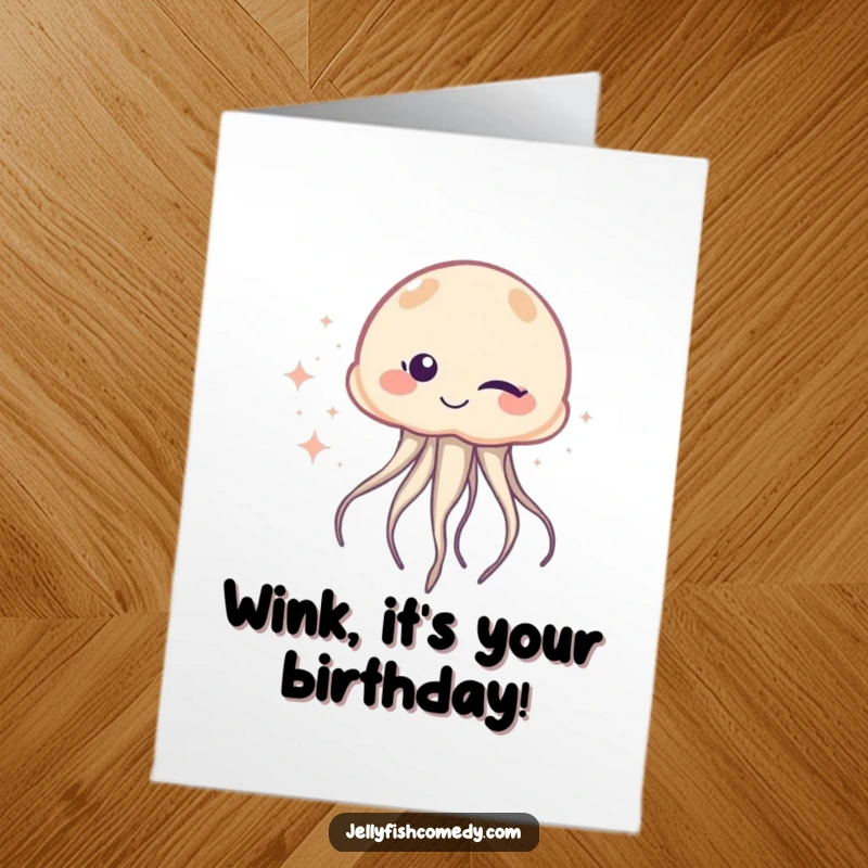 Free Printable Birthday Card of a playful jellyfish winking mischievously, leaving a shimmering trail of glittery sparkles.