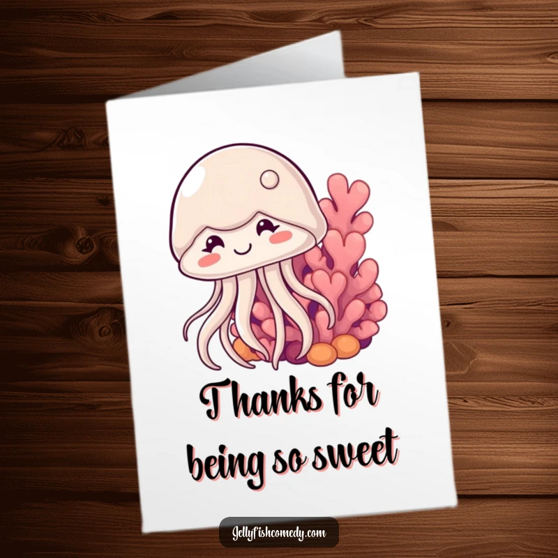 Free printable thank you card with a shyly smiling jellyfish emerging from behind coral, an endearing way to express thanks.