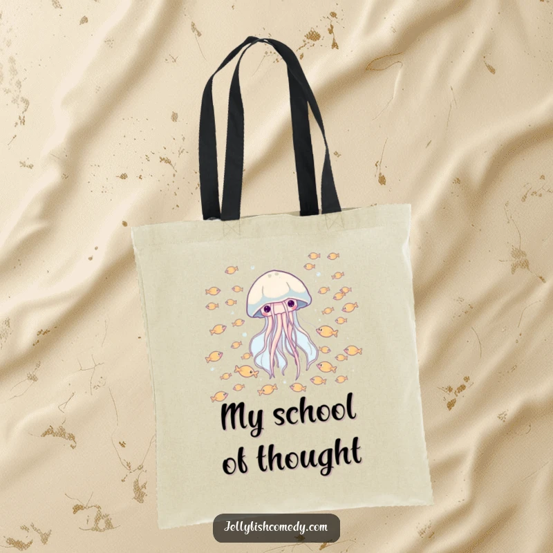 Funny tote bag with a happy jellyfish drifting through a school of tiny fish, great for shopping and carrying joy.
